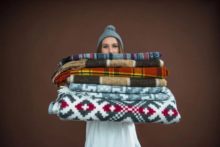 Woman Carrying Blankets