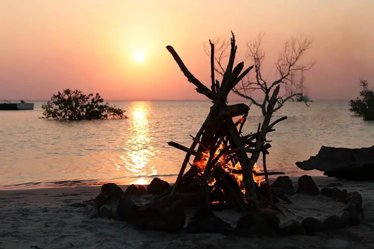 A beautiful camp fire on a tropical beach at sunset