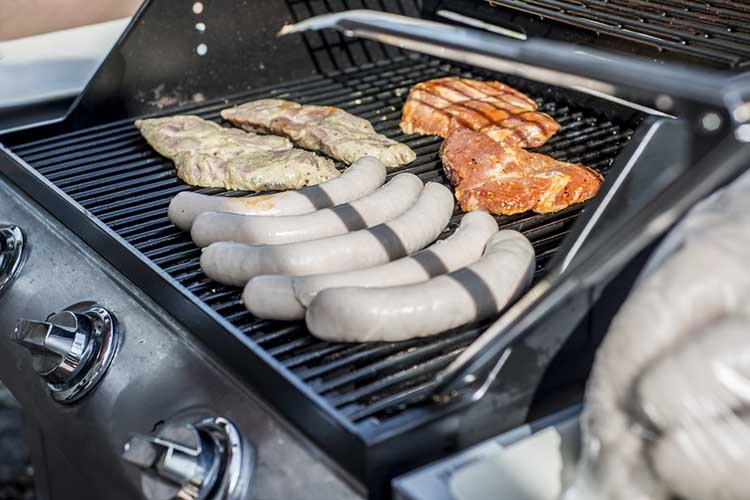 Barbecue grill bbq on propane gas grill steaks bratwurst sausages meat meal