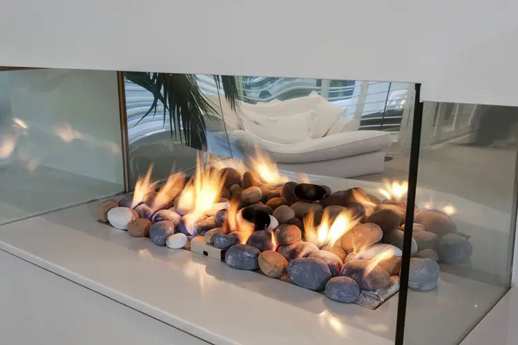 Modern glass fireplace, filled with stones instead of wood