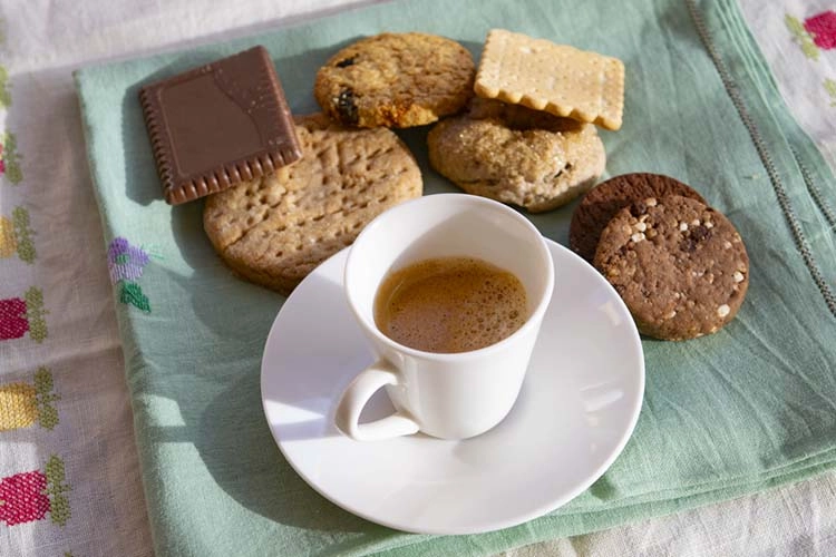 creamy espresso cup with homemade variety of cookies