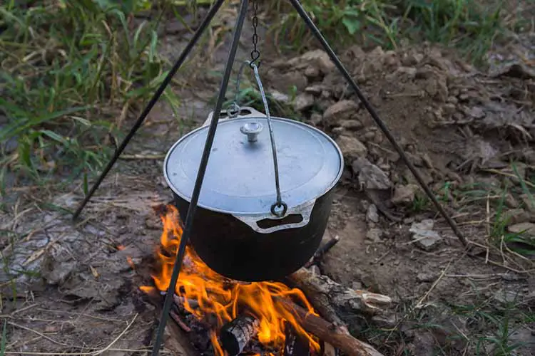 Dinner at the camp. The iron cauldron, blackened by the fire