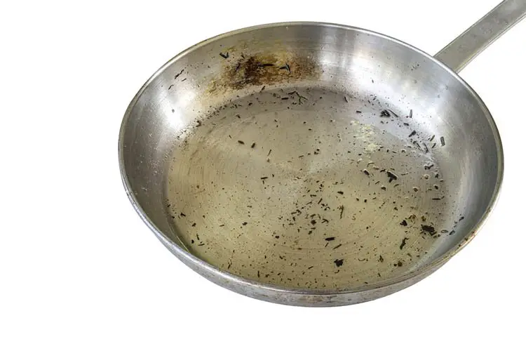 Skillet after used to fry food, isolated modern stainless steel