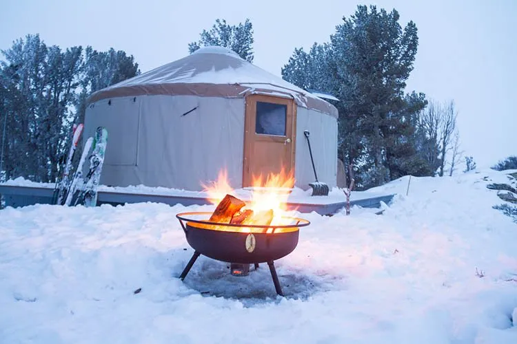 Yurt with fire place outside snow