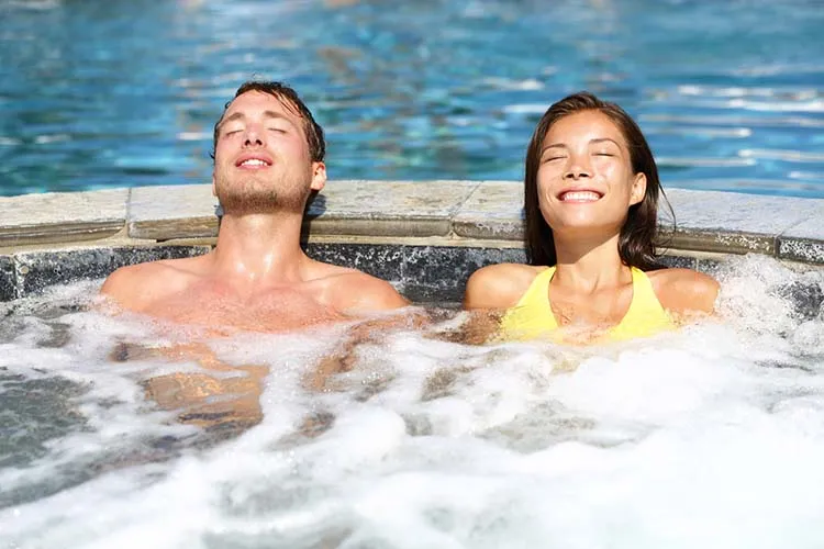 Spa couple relaxing enjoying jacuzzi hot tub