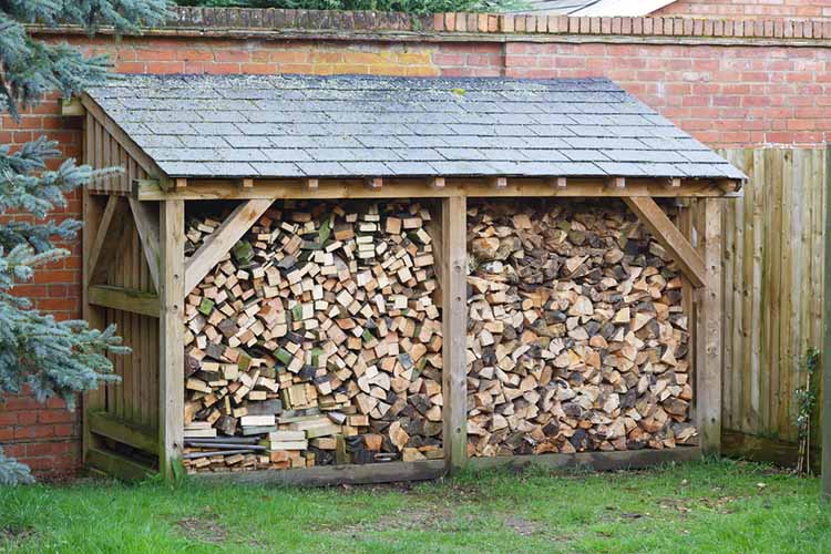 Large log store filled with firewood, timber
